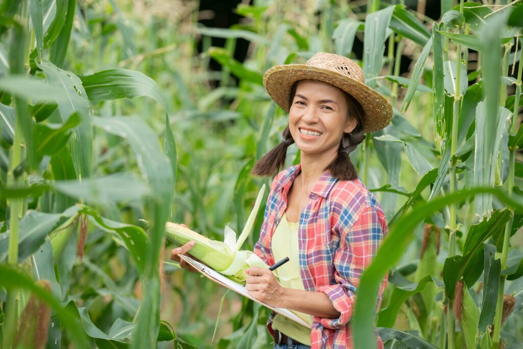 attractive-young-farmer-smiling-standing-corn-field-spring_11zon